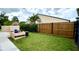 Grassy side yard with wooden fence, offering a secluded area for outdoor activities and relaxation at 761 Golden Sunshine Cir, Orlando, FL 32807