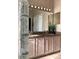 Bathroom vanity featuring double sinks, granite counters, and cabinet storage at 8647 Black Mesa Dr, Orlando, FL 32829