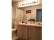Well-lit bathroom featuring a double vanity, decorative mirror, and ample counter space at 8647 Black Mesa Dr, Orlando, FL 32829