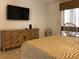 Bedroom boasts a flat-screen TV and a light wood dresser with plenty of drawer space at 8647 Black Mesa Dr, Orlando, FL 32829