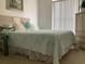 Bright bedroom with a comfy bed, decorative pillows, and a window with blinds at 8647 Black Mesa Dr, Orlando, FL 32829