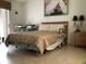 Comfortable bedroom features a large bed, a window with blinds, and neutral decor at 8647 Black Mesa Dr, Orlando, FL 32829