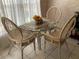 Cozy breakfast nook with a glass-top table and comfortable seating bathed in natural light at 8647 Black Mesa Dr, Orlando, FL 32829