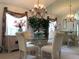 Bright dining room with a glass table, chandelier, and large mirror creating an elegant ambiance at 8647 Black Mesa Dr, Orlando, FL 32829