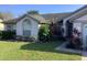 Well-maintained single-story home with lush landscaping, trimmed bushes and healthy green lawn at 8647 Black Mesa Dr, Orlando, FL 32829
