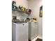 Convenient laundry room equipped with modern washer, dryer, and shelving for storage at 8647 Black Mesa Dr, Orlando, FL 32829
