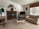 Inviting living room with a brick fireplace, neutral decor, and comfortable seating arrangements at 8647 Black Mesa Dr, Orlando, FL 32829