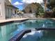 Sparkling pool with attached spa, patio seating, and a fenced backyard at 8647 Black Mesa Dr, Orlando, FL 32829