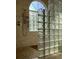 Tiled shower with glass block window and showerhead at 8647 Black Mesa Dr, Orlando, FL 32829