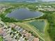 A captivating aerial view highlighting the surrounding lakes and green conservation areas near the neighborhood homes at 8752 Lookout Pointe Dr, Windermere, FL 34786