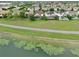 An aerial view of the well-maintained homes with screened-in pools, plus a walking path and pond view at 8752 Lookout Pointe Dr, Windermere, FL 34786