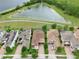 An aerial view showcases the home's proximity to a pond and paved walking trail at 8752 Lookout Pointe Dr, Windermere, FL 34786