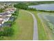 Panoramic aerial view of backyard screened enclosures next to a lakeside walking trail at 8752 Lookout Pointe Dr, Windermere, FL 34786