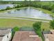 Aerial view highlighting backyard pools and patios, with scenic pond views at 8752 Lookout Pointe Dr, Windermere, FL 34786