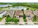 Aerial view of home featuring manicured lawns, multi-car garage, and a scenic backyard pond at 8752 Lookout Pointe Dr, Windermere, FL 34786