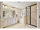 Main bathroom featuring double vanities, a walk-in shower, and a separate soaking tub at 8752 Lookout Pointe Dr, Windermere, FL 34786
