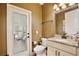 Well-lit half bathroom with granite countertop vanity and a decorative mirror at 8752 Lookout Pointe Dr, Windermere, FL 34786