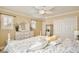 Cozy bedroom featuring a floral comforter, ceiling fan, and ensuite bathroom at 8752 Lookout Pointe Dr, Windermere, FL 34786