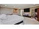 Comfortable bedroom with a large tv, neutral colored walls and carpet, and soft lighting at 8752 Lookout Pointe Dr, Windermere, FL 34786