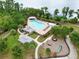 Aerial view of community pool, playground, cabanas, and recreational amenities surrounded by trees at 8752 Lookout Pointe Dr, Windermere, FL 34786