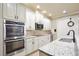 Updated kitchen featuring stainless steel appliances, granite countertops, and custom cabinetry at 8752 Lookout Pointe Dr, Windermere, FL 34786