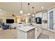 Open kitchen featuring white cabinets, granite countertops, stainless appliances, and breakfast bar at 8752 Lookout Pointe Dr, Windermere, FL 34786