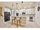 Modern kitchen with white cabinetry, stainless steel appliances, and a breakfast bar with seating at 8752 Lookout Pointe Dr, Windermere, FL 34786