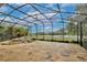 Large screened lanai with stone flooring, rock waterfall, and beautiful views of the property at 8752 Lookout Pointe Dr, Windermere, FL 34786