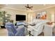 Cozy living room showcasing a plush white sectional, a blue recliner, and stylish decor at 8752 Lookout Pointe Dr, Windermere, FL 34786