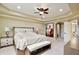 Serene main bedroom with neutral colors, a ceiling fan, and access to an en-suite bathroom at 8752 Lookout Pointe Dr, Windermere, FL 34786
