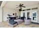 Covered outdoor patio with comfortable seating, ceiling fan, and french door access to the home at 8752 Lookout Pointe Dr, Windermere, FL 34786