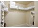 Spacious walk-in closet with wire shelving, hanging rods and a full-length mirror for storage at 8752 Lookout Pointe Dr, Windermere, FL 34786