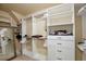 Organized walk-in closet featuring custom shelving, drawers and hanging space for optimal storage at 8752 Lookout Pointe Dr, Windermere, FL 34786