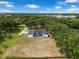 Spacious property with a screen-enclosed pool area near lush trees and an open yard at 9353 Gotha Rd, Windermere, FL 34786
