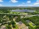 Scenic aerial view showcases lake panorama, lush greenery, and a pool home, capturing Florida's serene lifestyle at 9353 Gotha Rd, Windermere, FL 34786