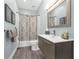 Well-appointed bathroom features a modern vanity, updated fixtures, and shower-tub combo at 9353 Gotha Rd, Windermere, FL 34786