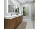Modern bathroom featuring double sinks, a contemporary design, and a glass-enclosed shower at 9353 Gotha Rd, Windermere, FL 34786