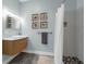 This bathroom has a modern vanity, framed artwork, and tiled shower at 9353 Gotha Rd, Windermere, FL 34786
