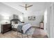 This staged bedroom features wood-look floors, a ceiling fan, and neutral tones at 9353 Gotha Rd, Windermere, FL 34786