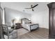 This bedroom boasts a ceiling fan, seating area, and neutral color palette at 9353 Gotha Rd, Windermere, FL 34786
