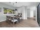 Dining area featuring a modern table set, stylish pendant lights, and view to a green outdoor space at 9353 Gotha Rd, Windermere, FL 34786