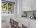 Dining area featuring sleek white cabinetry and a garden view that enhances the room's natural light at 9353 Gotha Rd, Windermere, FL 34786