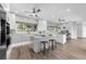 Open-concept kitchen with an island, stainless steel appliances, and bar stool seating near the dining area at 9353 Gotha Rd, Windermere, FL 34786