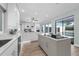 Open kitchen with a large island, stainless steel appliances, and seamless access to outdoor pool area at 9353 Gotha Rd, Windermere, FL 34786