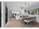 Bright and airy kitchen and dining area with white cabinetry and stainless steel appliances at 9353 Gotha Rd, Windermere, FL 34786