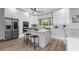 Modern kitchen featuring white cabinets, stainless steel appliances, and a center island with seating at 9353 Gotha Rd, Windermere, FL 34786