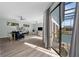 Living room with contemporary furniture and a view of the outdoor pool area through large sliding glass doors at 9353 Gotha Rd, Windermere, FL 34786