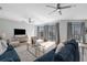 Elegant living room showcasing a large window with a pool view, stylish decor, and modern furniture at 9353 Gotha Rd, Windermere, FL 34786
