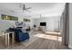 Bright living room featuring hardwood floors, modern furniture, and natural light from multiple windows at 9353 Gotha Rd, Windermere, FL 34786