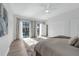 Bright bedroom with large windows overlooking the pool, wood-style flooring, and large closet at 9353 Gotha Rd, Windermere, FL 34786